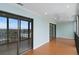 Bright living room featuring hardwood floors, and large glass doors opening onto the balcony with city views at 7877 E Mississippi Ave # 1107, Denver, CO 80247