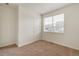 Cozy bedroom with neutral carpet and a window allowing for natural light and outdoor views at 845 Leeward St, Lochbuie, CO 80603