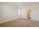 Bedroom featuring neutral carpet, a window with blinds, and an en-suite bathroom at 845 Leeward St, Lochbuie, CO 80603