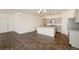 Spacious kitchen and dining area with gray cabinets, granite countertops, and stainless steel appliances at 845 Leeward St, Lochbuie, CO 80603