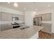 Modern kitchen featuring granite countertops, stainless steel appliances and gray cabinets at 845 Leeward St, Lochbuie, CO 80603