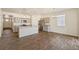 Open-concept kitchen featuring stainless steel appliances, granite countertops, and stylish gray cabinetry at 845 Leeward St, Lochbuie, CO 80603