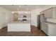 Modern kitchen featuring granite countertops, stainless steel appliances and gray cabinets at 845 Leeward St, Lochbuie, CO 80603