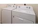 Laundry room featuring a white washing machine and dryer, for efficient laundry services at 845 Leeward St, Lochbuie, CO 80603