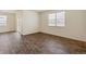 Bright, open living space with large windows, and modern wood-look flooring, creating an airy atmosphere at 845 Leeward St, Lochbuie, CO 80603