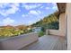 Balcony with a view of mountains, greenery, and houses, offering a serene outdoor experience at 10592 Raven Run, Littleton, CO 80125