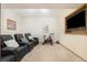 Finished basement with comfortable seating, a mounted TV, and exercise equipment, perfect for entertainment and fitness at 10592 Raven Run, Littleton, CO 80125