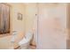 Bright bathroom featuring a toilet, walk-in shower, and vanity, offering a convenient and comfortable space at 10592 Raven Run, Littleton, CO 80125