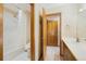 Bathroom with a tub/shower, toilet, and a vanity with a sink, providing a functional and well-maintained space at 10592 Raven Run, Littleton, CO 80125