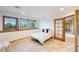 Bedroom featuring three windows, carpet floors, and neutral colors to complement the rest of the house at 10592 Raven Run, Littleton, CO 80125