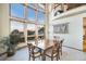 Elegant dining room boasts large windows with scenic views and a polished wood table at 10592 Raven Run, Littleton, CO 80125