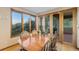 Dining room featuring hardwood floors, large windows, and access to a patio with an outdoor grill at 10592 Raven Run, Littleton, CO 80125
