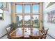 Dining room with beautiful views and wooden table with chairs at 10592 Raven Run, Littleton, CO 80125