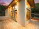 Modern home exterior with floor to ceiling windows and a wood deck at 10592 Raven Run, Littleton, CO 80125