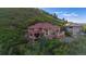 Beautiful home with a red tile roof and spacious balconies, surrounded by lush greenery and mountain views at 10592 Raven Run, Littleton, CO 80125