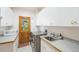 Efficient laundry room with stainless steel washer and dryer, ample counter space, and storage cabinets at 10592 Raven Run, Littleton, CO 80125