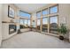 Bright living room with a cozy fireplace and large windows offering panoramic views at 10592 Raven Run, Littleton, CO 80125