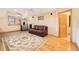 Bright living room with hardwood floors, area rug, leather couch, and an exterior view at 10592 Raven Run, Littleton, CO 80125