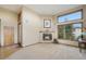 Inviting living room with a fireplace, large windows, and natural light at 10592 Raven Run, Littleton, CO 80125