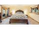 Main bedroom features a decorative accent wall, doors to the outside, and lots of natural light at 10592 Raven Run, Littleton, CO 80125