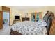 Main bedroom offers carpet floors and neutral colors to complement the wooden furniture at 10592 Raven Run, Littleton, CO 80125
