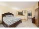Main bedroom offers carpet floors and neutral colors to complement the doors leading to the bathroom at 10592 Raven Run, Littleton, CO 80125
