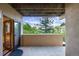 Covered patio with a leafy outdoor view at 10592 Raven Run, Littleton, CO 80125