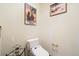 This powder room offers a toilet and decorative accents, providing a functional space at 10592 Raven Run, Littleton, CO 80125