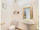 This powder room offers a pedestal sink and decorative accents, providing a functional space at 10592 Raven Run, Littleton, CO 80125