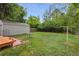 Spacious backyard with lush greenery and a detached garage, perfect for outdoor activities and storage at 2709 S Franklin St, Denver, CO 80210