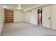 Spacious basement featuring neutral carpet and a built-in shelving unit at 2709 S Franklin St, Denver, CO 80210