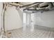 Unfinished basement with painted walls, geometric tile floor, and exposed piping provides potential for customization at 2709 S Franklin St, Denver, CO 80210