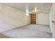 Finished basement with neutral carpet and a large bookshelf at 2709 S Franklin St, Denver, CO 80210