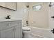 Bathroom featuring a white tiled shower/tub and a vanity with matte black faucet at 2709 S Franklin St, Denver, CO 80210