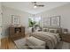 This staged bedroom features a ceiling fan, hardwood floors and a corner window at 2709 S Franklin St, Denver, CO 80210