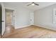 This empty bedroom offers hardwood floors and an open doorway to an ensuite bathroom at 2709 S Franklin St, Denver, CO 80210
