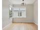 Light-filled bedroom with hardwood floors, trim, and a window offering neighborhood views at 2709 S Franklin St, Denver, CO 80210