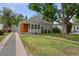 A charming single-story home with a gray exterior, well-maintained lawn, and a detached garage at 2709 S Franklin St, Denver, CO 80210