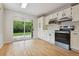 Eat in kitchen has updated stainless steel appliances, access to the backyard, and wood floors at 2709 S Franklin St, Denver, CO 80210