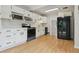 Modern kitchen with white cabinets, stainless steel appliances, and ample counter space at 2709 S Franklin St, Denver, CO 80210