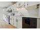 This updated kitchen includes modern appliances and sleek black hardware at 2709 S Franklin St, Denver, CO 80210