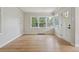 Spacious living room with hardwood floors and a large window offering natural light and views of the yard at 2709 S Franklin St, Denver, CO 80210