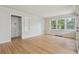 Bright room features hardwood floors, a built-in cabinet, and large windows providing ample natural light at 2709 S Franklin St, Denver, CO 80210