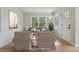 Bright living room featuring hardwood floors, a large picture window, and neutral decor. Virtually staged at 2709 S Franklin St, Denver, CO 80210