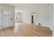 Inviting room featuring hardwood floors, a large window, and easy access to other rooms in the home at 2709 S Franklin St, Denver, CO 80210