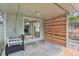 Covered patio featuring a porch swing, sliding glass door to the house, and a wooden privacy screen at 2709 S Franklin St, Denver, CO 80210