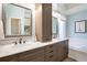 Well-lit bathroom with a double vanity, marble countertops, and a separate bathtub at 87 Canongate Ln, Highlands Ranch, CO 80130