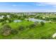 Expansive aerial view showcasing a park with tennis courts and playgrounds amidst a residential area at 245 Main St, Broomfield, CO 80020
