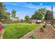 Spacious fenced backyard with a well-maintained lawn, shed, hot tub, and garden area at 245 Main St, Broomfield, CO 80020