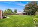 Large backyard with lush green grass and mature trees at 245 Main St, Broomfield, CO 80020